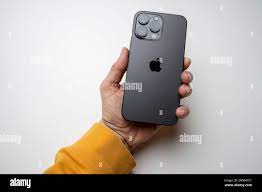 A man holds the latest iPhone 14 Pro Max in Space Black. Apple's latest  phone is equipped with three cameras Stock Photo - Alamy