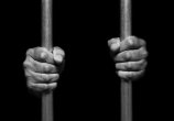 12585481-Person-s-hands-holding-prison-bars.jpg